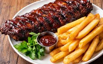 bbq ribs with sauce and french fries on the side